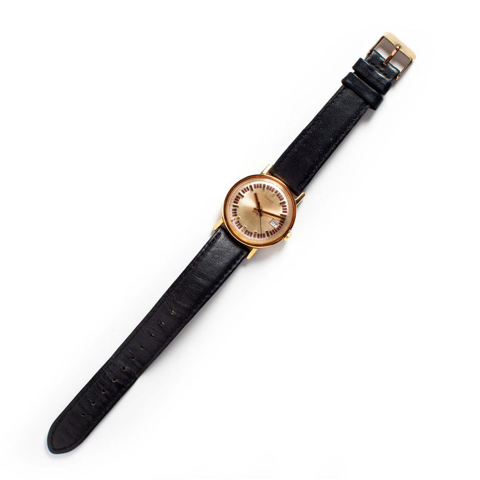 flatlay of The 1974 Timex Mercury Calendar Gold