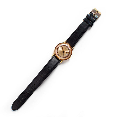 flatlay of The 1974 Timex Mercury Calendar Gold