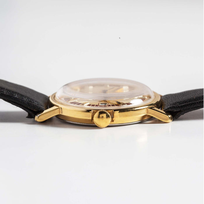 material shot of the side of The 1974 Timex Mercury Calendar Gold