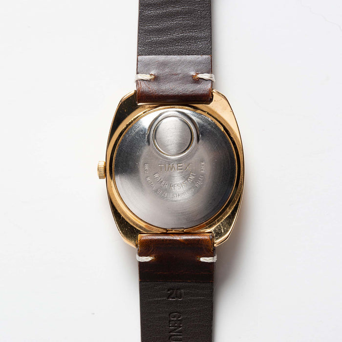flatlay of 1975 Timex Electric Dynabeat Time Zone, shown from back