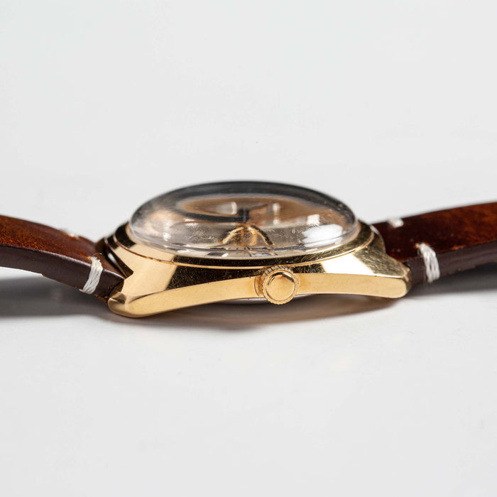 flatlay of 1975 Timex Electric Dynabeat Time Zone, shown from the side