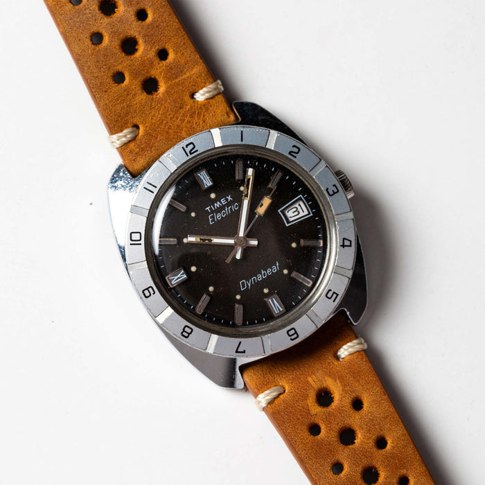 flatlay of 1976 Timex Electric Dynabeat, shown clos eup