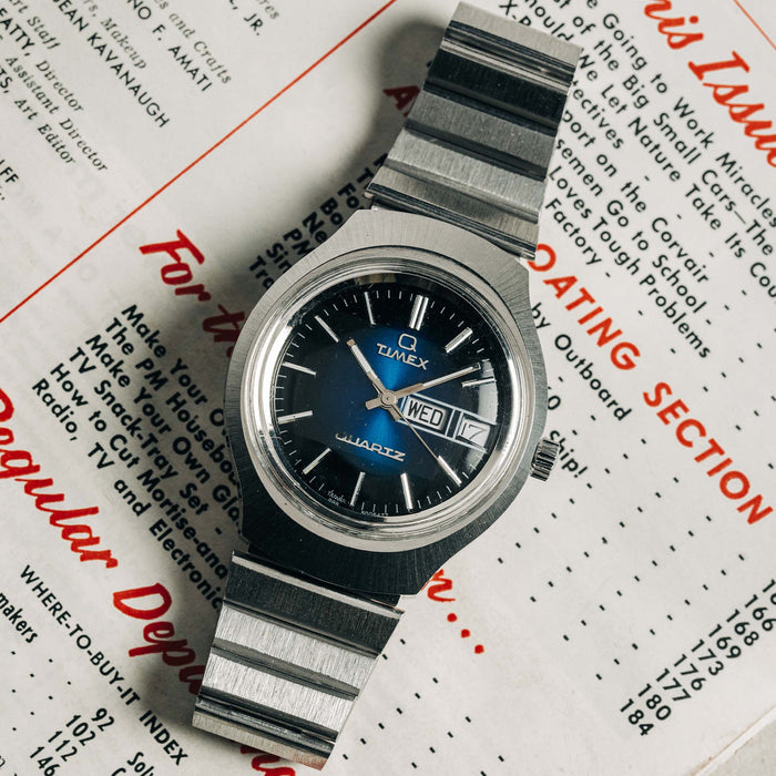 flatlay of the 1977 Timex Blue Dial Q Quartz, on a newspaper