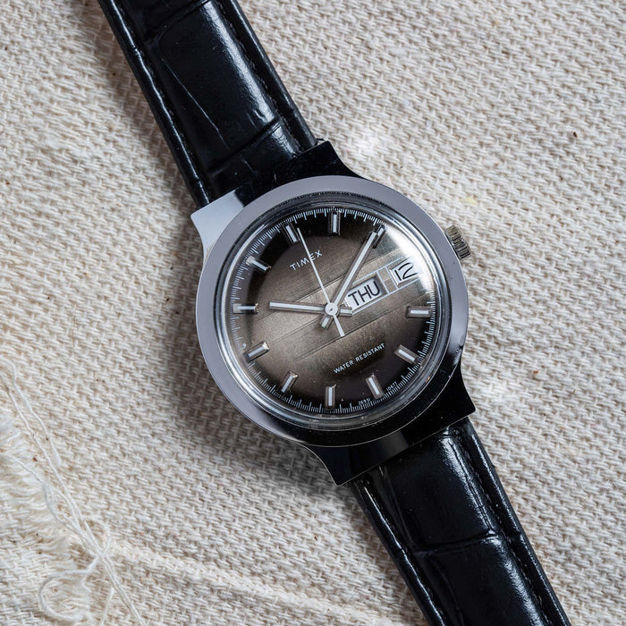 flatlay of the 1977 Timex Marlin M106 on a white cloth background