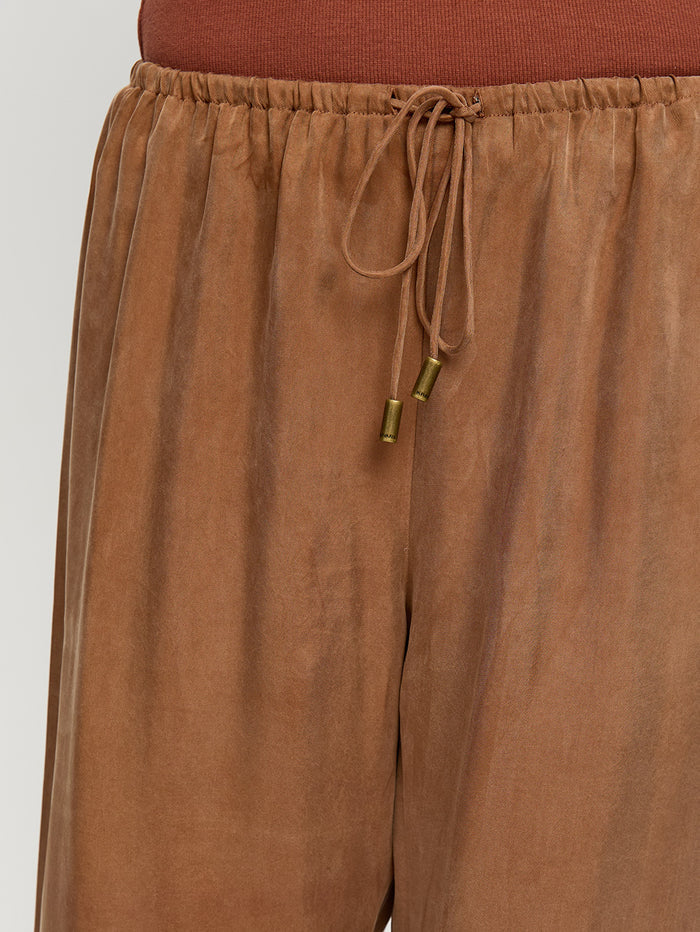Brown drawstring pants on a white background