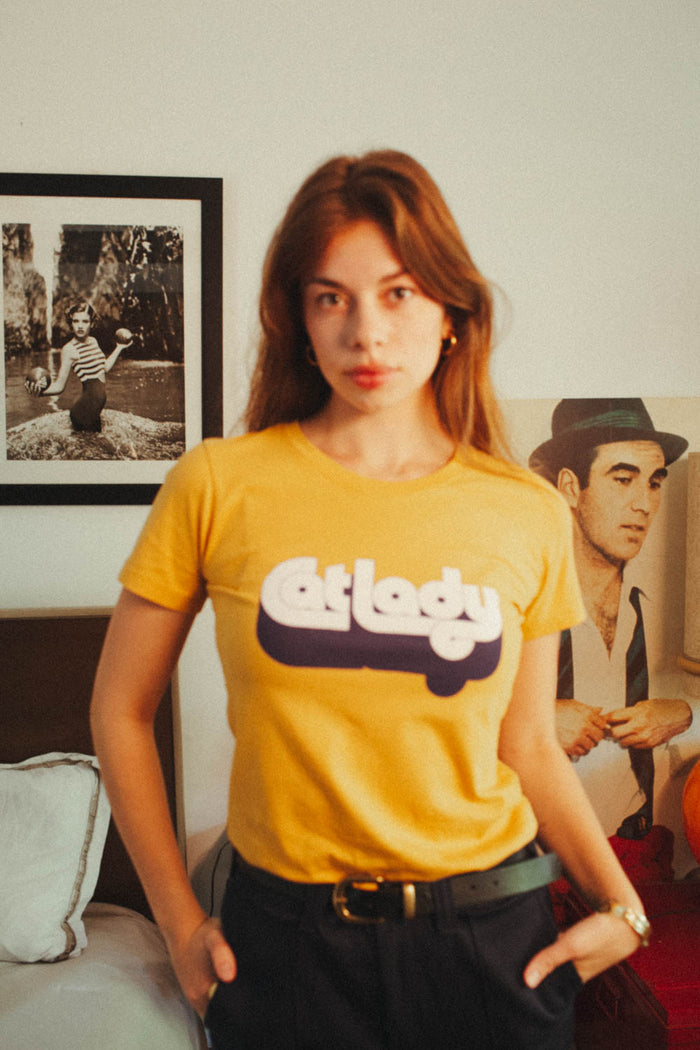Woman wearing orange "Cat Lady" shirt
