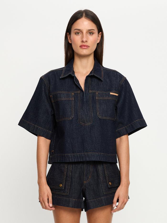 Model wearing denim set on white background