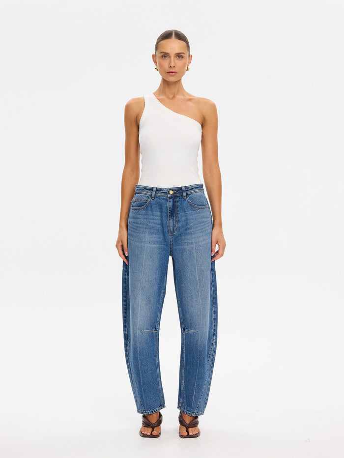 KIVARI Dylan Jeans in Drift Blue – front-facing product photo with white one-shoulder top and sandals