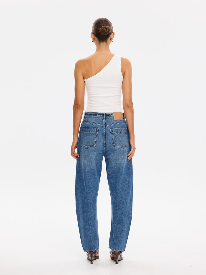 KIVARI Dylan Jeans in Drift Blue – back view styled with a white one-shoulder top