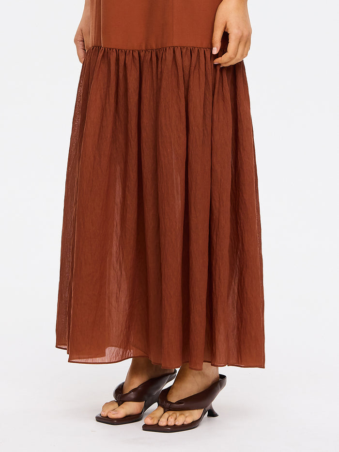 KIVARI Elanor Maxi Dress in Hazel – close-up detail of gathered tiered skirt and waist on women's hazel maxi dress