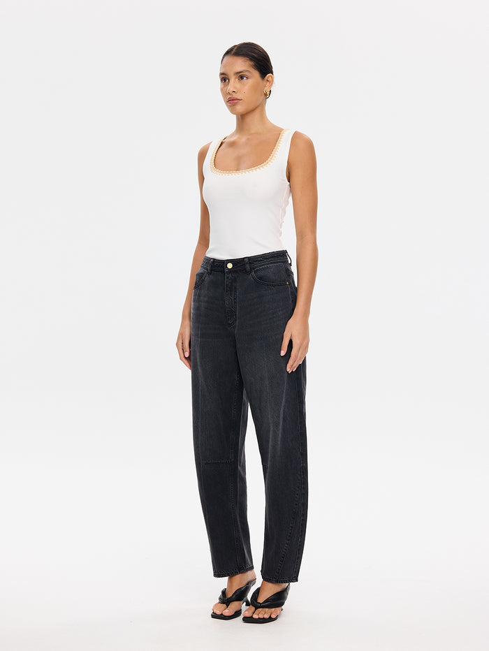KIVARI Esme ivory tank top with wide-leg denim jeans and sandals, angled front view