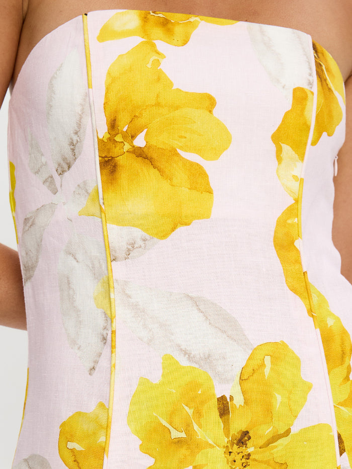 Close-up of a floral dress with yellow flowers on a white background