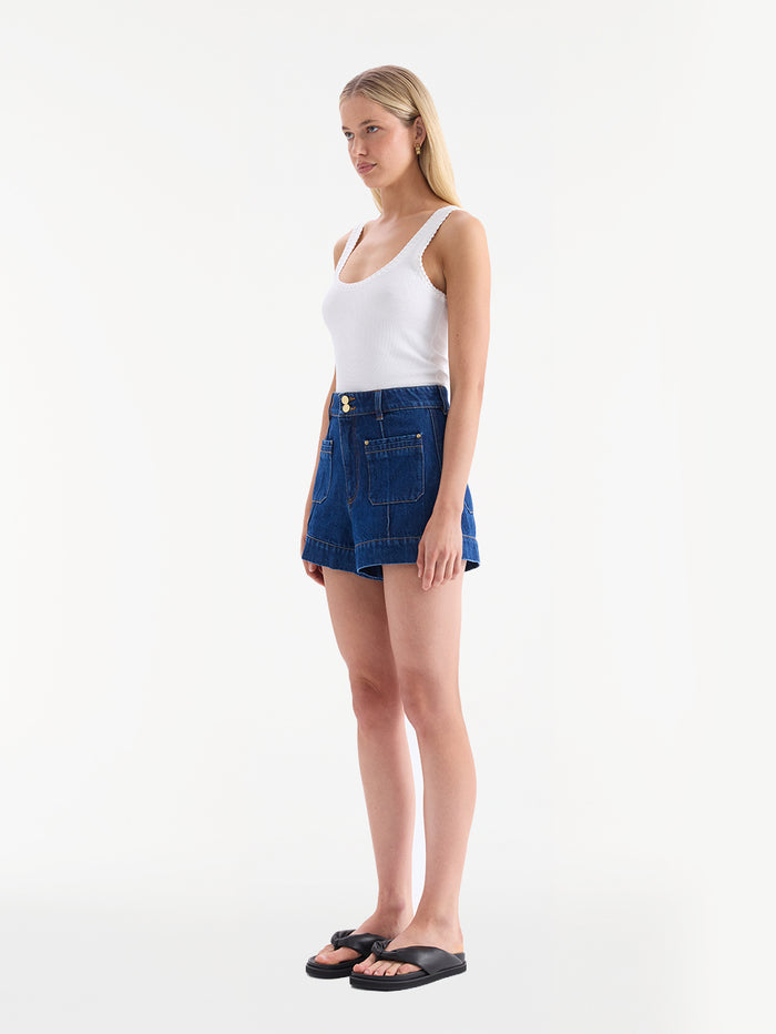 KIVARI Hanna denim shorts with white tank top, side profile view
