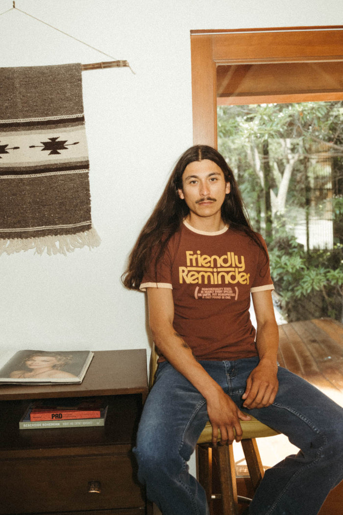 Man wearing "Homophobia Is Only Found In One" shirt by The Bee & The Fox
