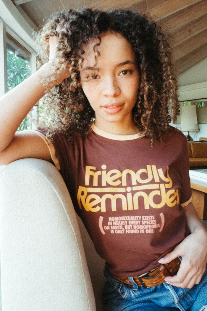 Woman wearing "Homophobia Is Only Found In One" shirt by The Bee & The Fox