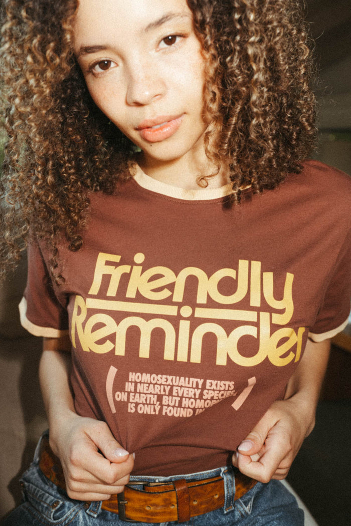 Woman wearing "Homophobia Is Only Found In One" shirt by The Bee & The Fox