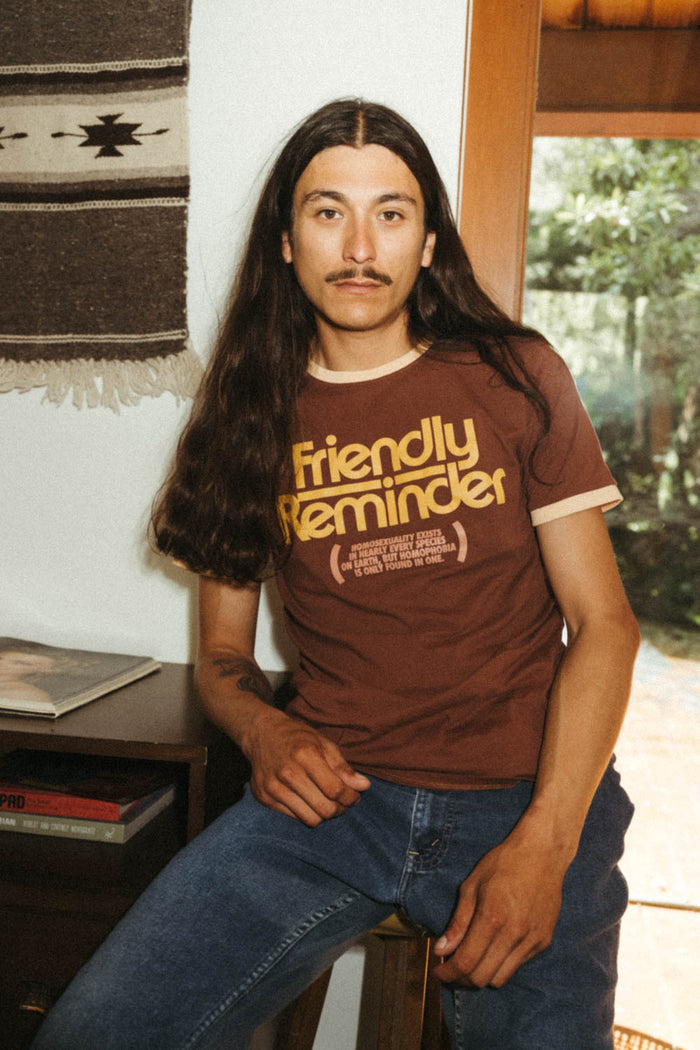 Man wearing "Homophobia Is Only Found In One" shirt by The Bee & The Fox