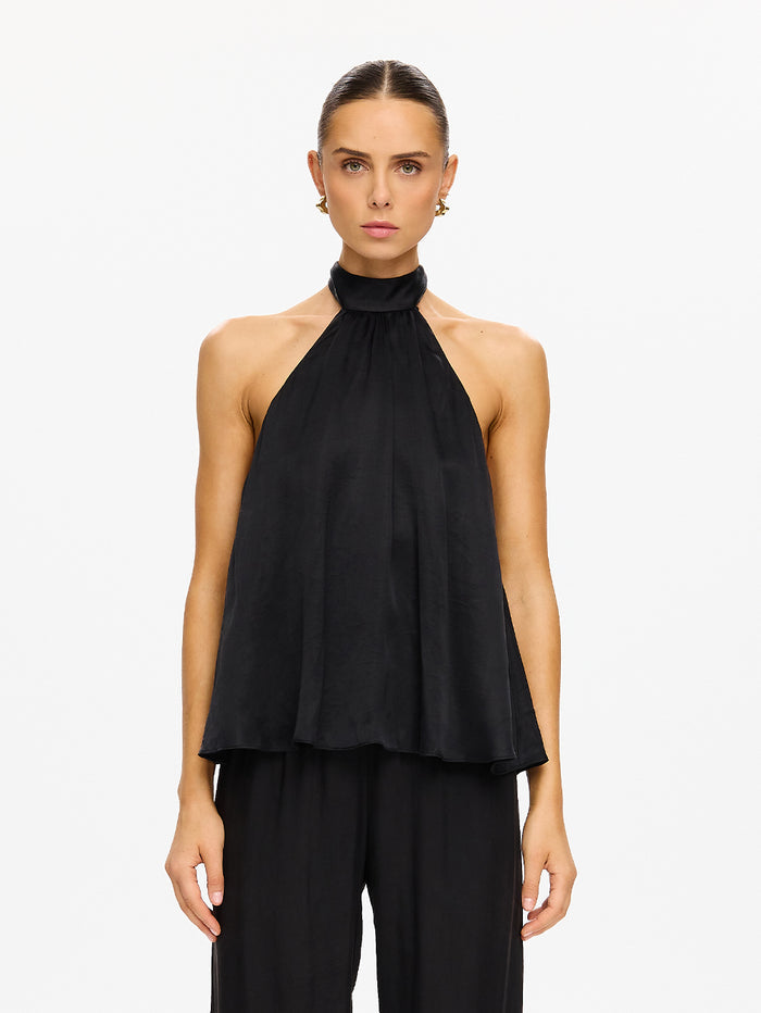 KIVARI Jaxon Halter Top in Black – model wearing women's black halter neck top with matching wide-leg pants