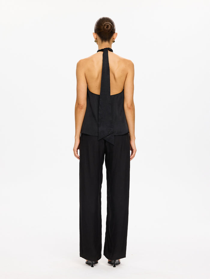 KIVARI Jaxon Halter Top in Black – back view showing open back and halter tie, model wearing women's black halter top with wide-leg pants