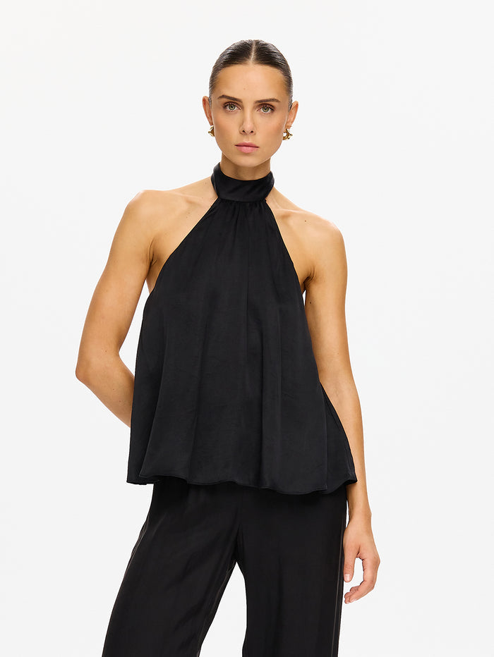 KIVARI Jaxon Halter Top in Black – three-quarter front view of model wearing women's black halter neck top with wide-leg pants