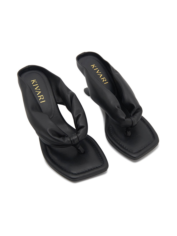Black sandals with 'Kivari' branding on a white background
