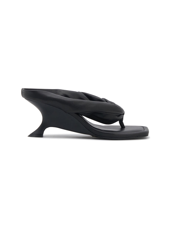 Black sandal with a unique design on a white background