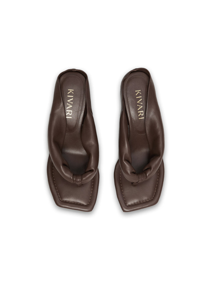 Pair of brown heels with 'Kivari' branding on a white background