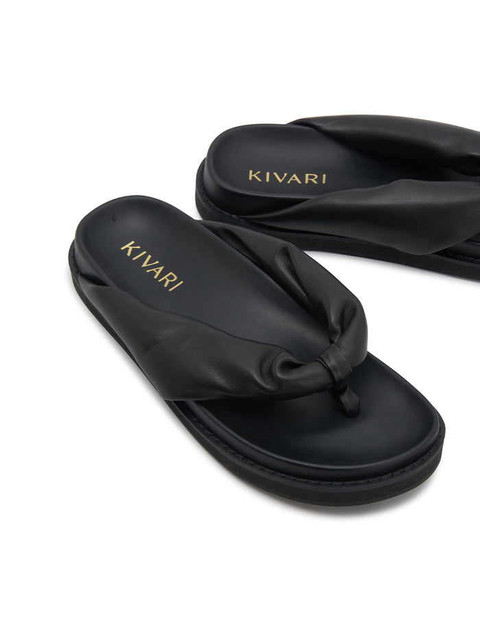 Black sandals with 'Kivari' branding on a white background