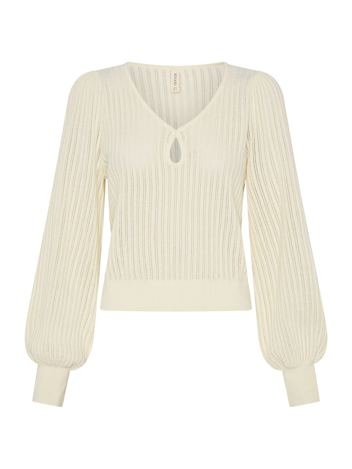 Cream-colored ribbed sweater on a white background