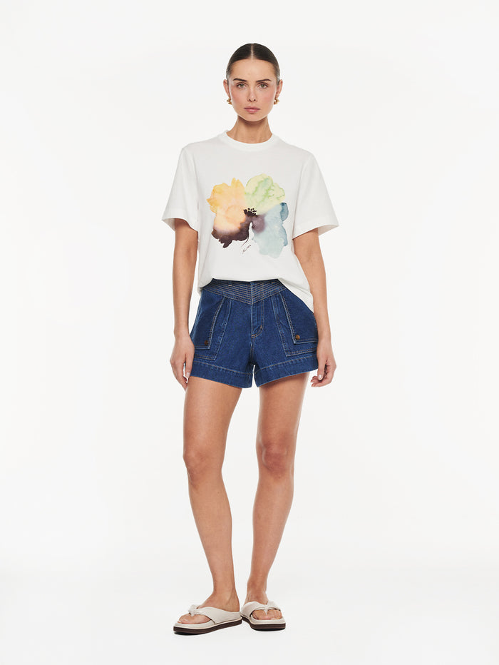 Lotte Tee in Yellow print, graphic t-shirt with watercolor floral design styled with denim shorts