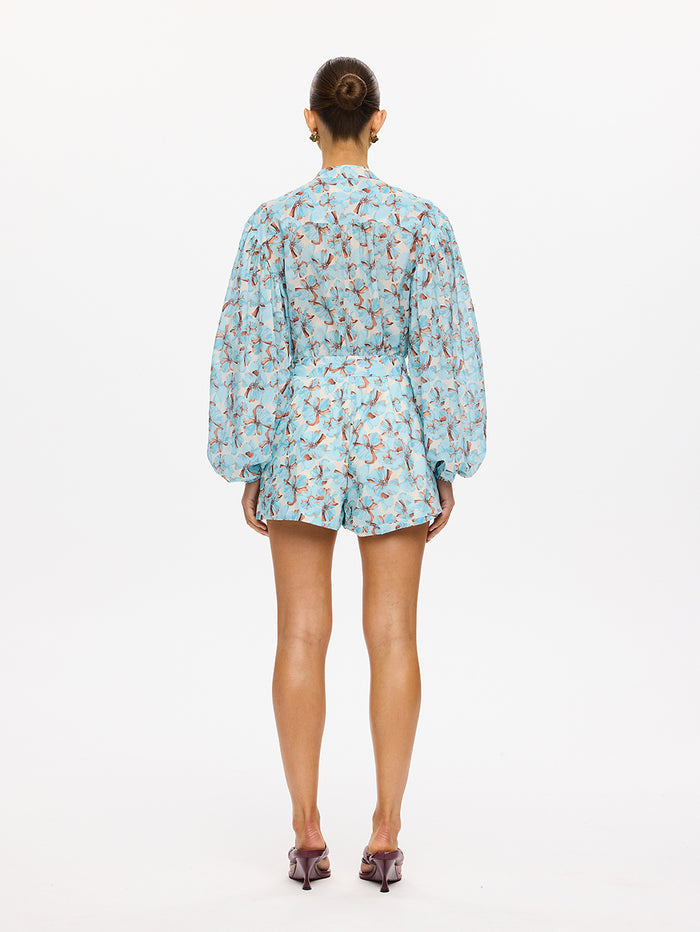 KIVARI Lydia Playsuit in Mint - back view of model in mint teal floral print long-sleeve playsuit