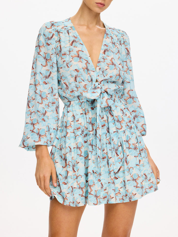 KIVARI Lydia Tie Front Mini Dress in Mint - close-up of tie waist detail on teal floral print dress, model photo