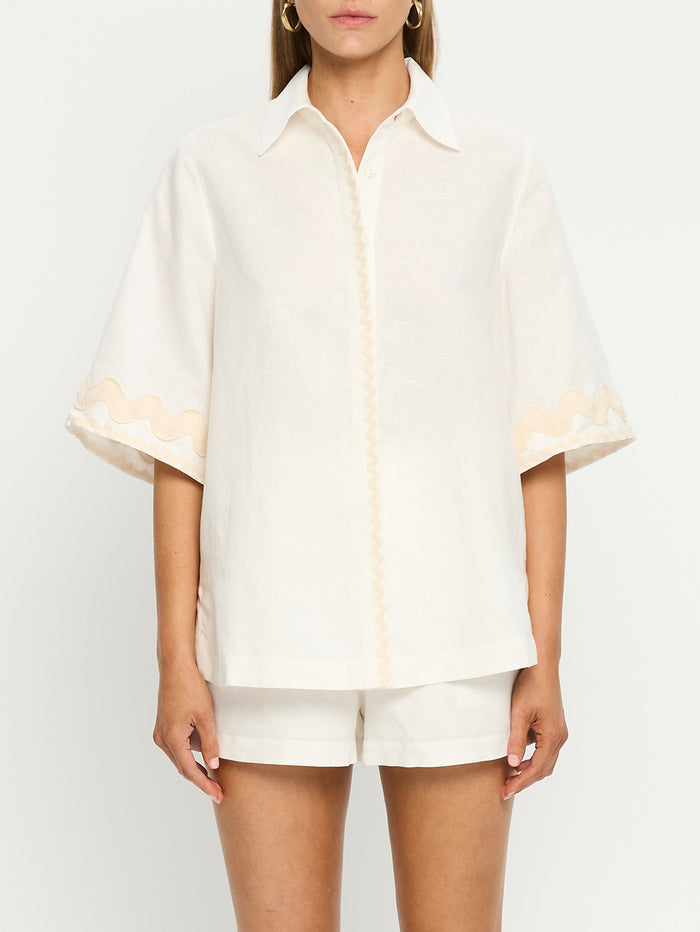 Woman in white linen shirt