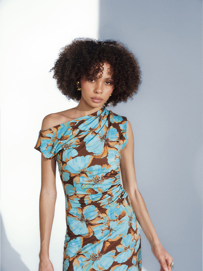 KIVARI Studio Creative floral mini dress - model wearing blue and brown one-shoulder ruched dress
