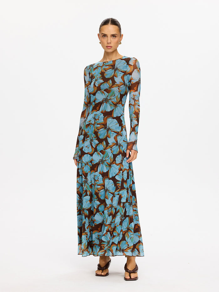 KIVARI Nieve Mesh Maxi Dress in Blue Floral Print – model wearing women's long-sleeve floral mesh maxi dress, full-length side view