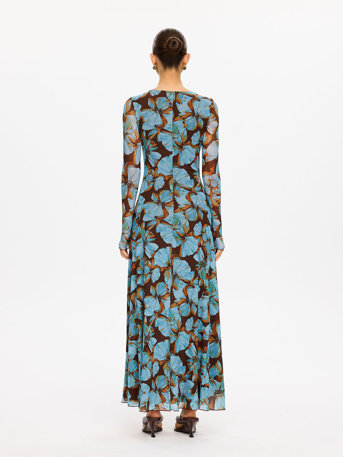 KIVARI Nieve Mesh Maxi Dress in Blue Floral Print – back view of model wearing women's long-sleeve floral mesh maxi dress