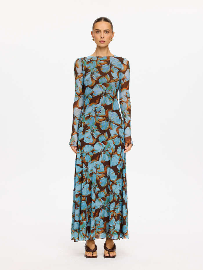 KIVARI Nieve Mesh Maxi Dress in Blue Floral Print – full-length model in women's long-sleeve floral mesh maxi dress showing flared skirt