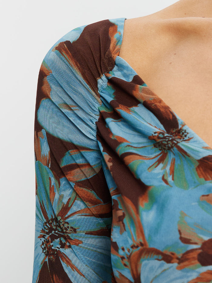 KIVARI Nieve Mesh Top in Blue Floral Print – fabric close-up detail of blue floral mesh wrap neckline