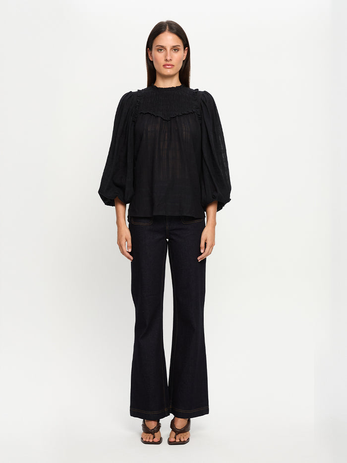 Woman wearing a black outfit on a white background