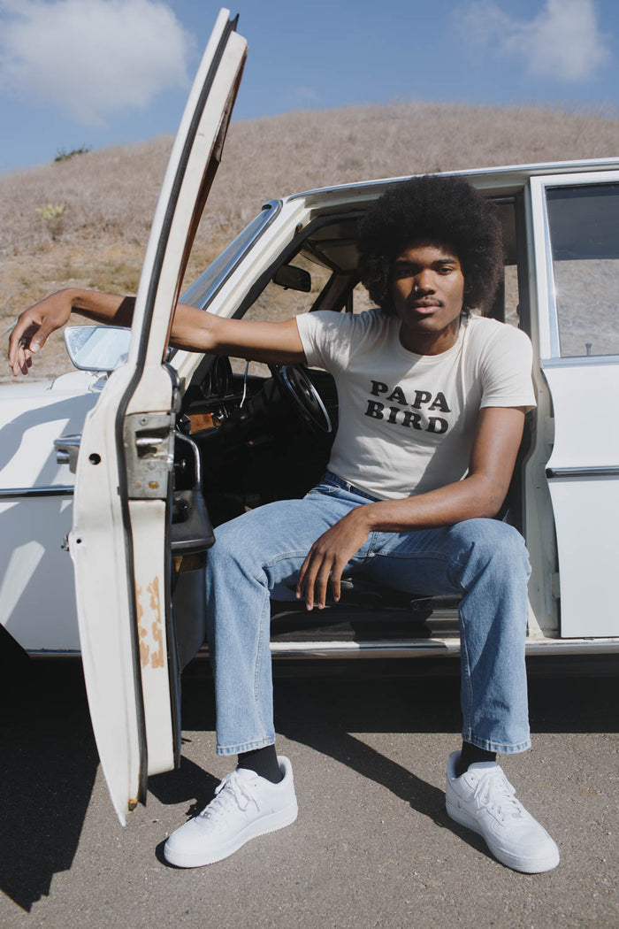 Man sat in a car with the door open wearing Papa Bird Shirt for Men by The Bee and The Fox