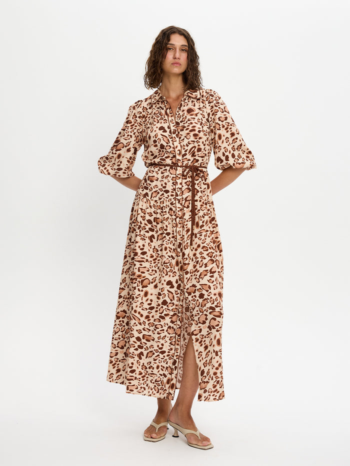 Woman wearing a leopard print dress on a white background