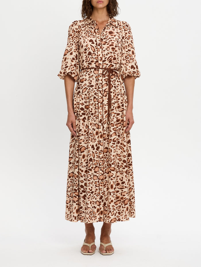 Woman wearing a leopard print dress on a white background