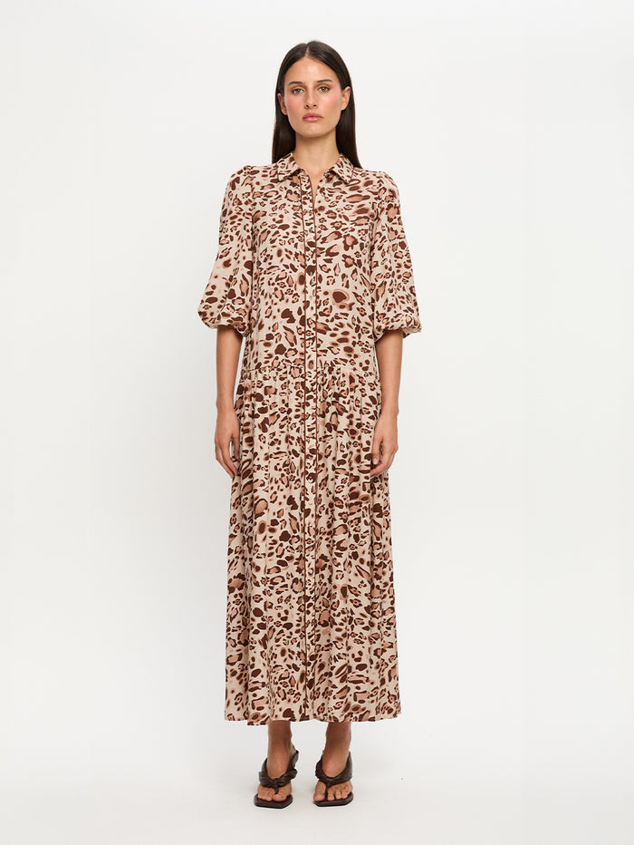 Woman wearing a leopard print dress on a white background
