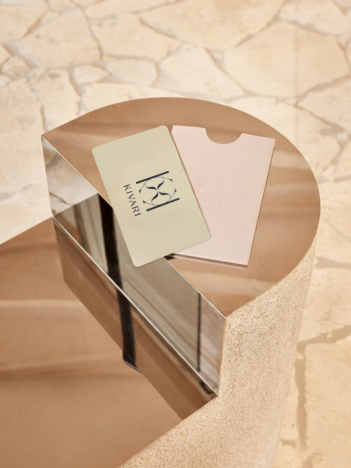KIVARI physical gift cards in sage green and blush pink on a marble pedestal