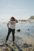 Man standing in the sea wearing Proud Papa Shirt for Men by The Bee and The Fox