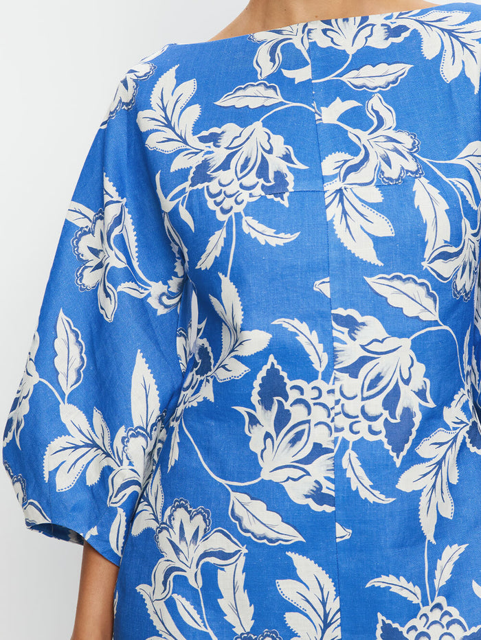 Blue fabric with white floral pattern on a plain background