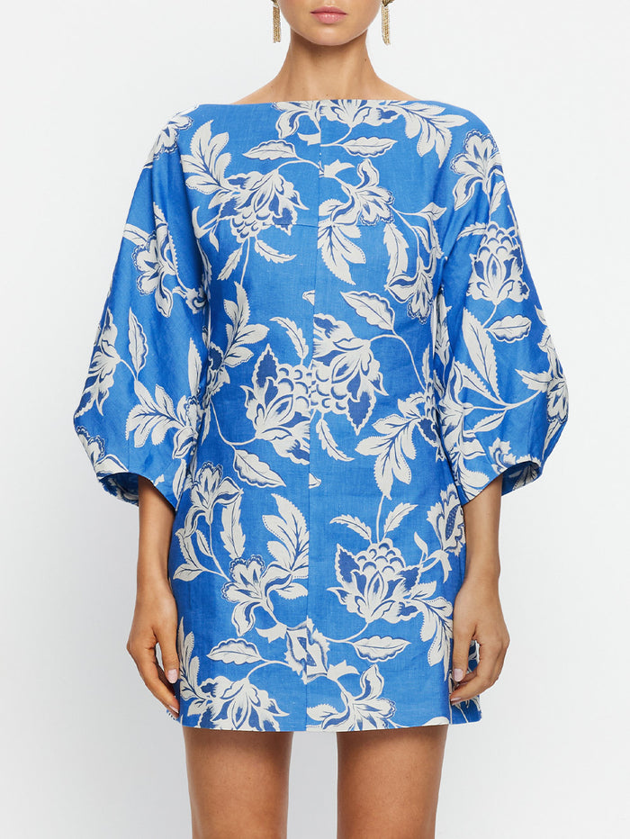 Blue floral dress worn by a model on a white background