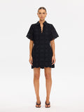 Woman wearing a black dress on a white background