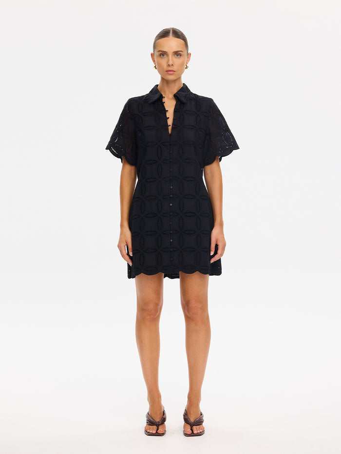 Woman wearing a black dress on a white background