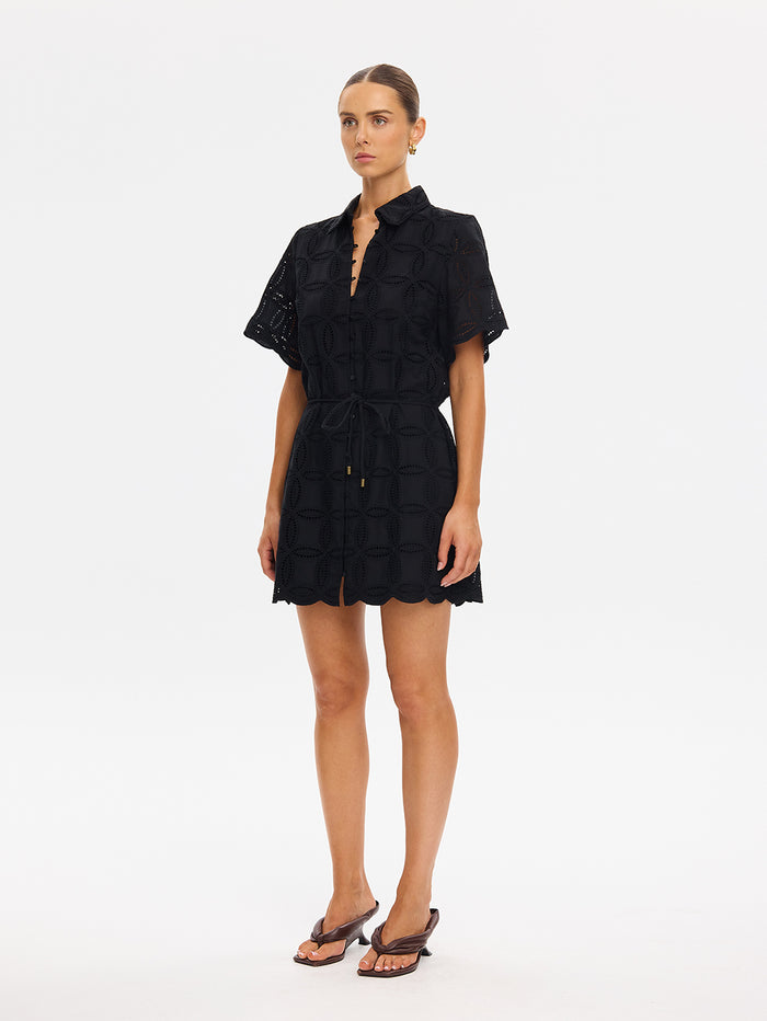 Woman wearing a black dress on a white background